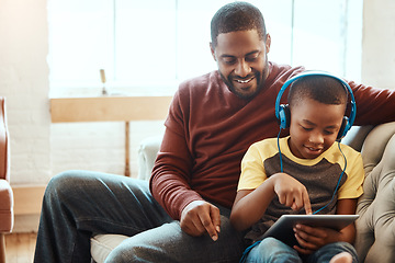 Image showing Tablet, happy and dad with his son on a sofa watching a funny, comic or meme video on social media. Relax, smile and African man streaming a movie with child on mobile device while relaxing together.