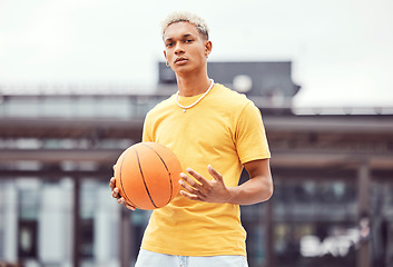 Image showing Basketball, young man and basketball player with sport in park with portrait in city and exercise outdoor. Fitness, athlete on basketball court, focus and urban with sports motivation and training.