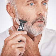 Image showing Senior man, shaving and electric razor for hair care, beauty and cosmetics on studio background. Mature male, elderly guy and shave for facial routine, beard trim and wellness for health and skincare