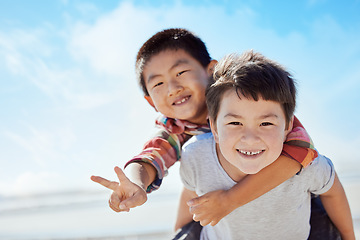 Image showing Beach, peace sign and Asian children hug on Japan travel vacation for calm, freedom and outdoor nature. Blue sky, ocean sea or happy youth portrait of fun kids or friends on holiday playing piggyback