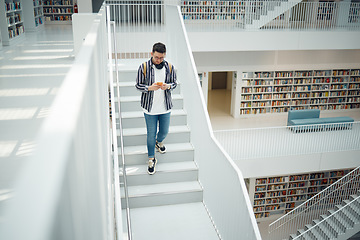 Image showing College student, walking stairs and campus with phone, reading and communication on social media. Man, university student and smartphone app for email in library for education, learning and studying