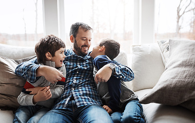 Image showing Hug, playful and father with children on the sofa for love, care and relax in their family home. Happy, funny and dad with boy kids for quality time, affection and comedy on the couch of a house