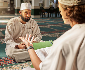 Image showing Quran, muslim and mosque with an imam teaching a student about religion, tradition or culture during eid. Islam, book or worship with a religious teacher and islamic male praying together for ramadan