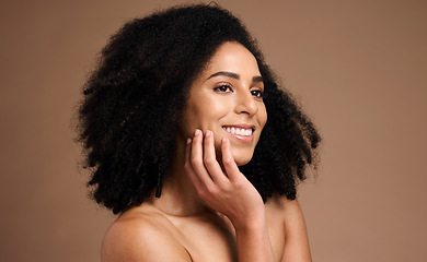 Image showing Black woman, smile and studio with beauty, makeup and cosmetic wellness with hands, face glow and afro hair. Model, skin health and facial cosmetics, self care and aesthetic by brown studio backdrop