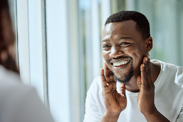 Image showing Beauty, face and skincare with a black man looking in the bathroom mirror during his morning routine at home. Skin, head and reflection with a handsome male grooming for wellness or natural care