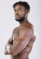 Image showing Confident, muscular and portrait of a black man with arms crossed isolated on a grey studio background. Fitness, health and African athlete with muscle, power and bodybuilding body on a backdrop