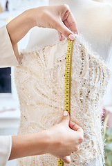 Image showing Hands, fashion and measuring tape by woman designer for dress, pattern and details of fabric in studio. Creative, girl and measurement by dressmaker working on luxury, elegant and classic clothing