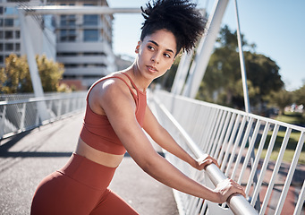 Image showing Black woman, fitness and stretching, running in city and exercise outdoor, focus and strong with muscle training. Runner, athlete and sport motivation, person on bridge for run and health wellness