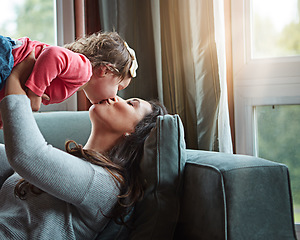 Image showing Relax, happy and kiss with mother and baby on sofa for bonding, quality time and child development. Growth, support and trust with mom and daughter in family home for health, connection and care