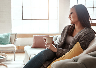 Image showing Morning tea, woman think and home living room sofa with a person happy dreaming. Tea drink, calm lounge lifestyle and female on a house couch with happiness on weekend with a relax smile and coffee