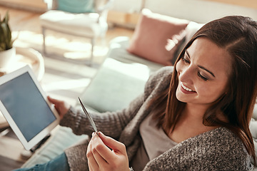 Image showing Tablet, credit card and woman on sofa online shopping in home living room. Fintech, ecommerce and happy female with technology buying products, banking payment or paying for goods on virtual store.