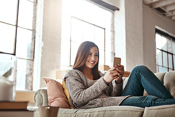 Image showing Relax, phone and woman on a sofa, happy and texting on social media while resting in her home. Girl, smartphone and app for chatting, online dating and internet, search and streaming in a living room