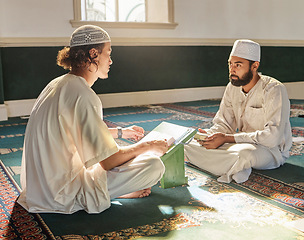 Image showing Quran, muslim and mosque with an imam teaching a student about religion, tradition or culture during eid. Islam, book or worship with a religious teacher and islamic male praying together for ramadan