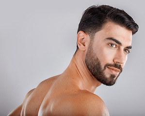 Image showing Skincare, health and man in a studio for a hygiene, wellness and natural cosmetic face routine. Beauty, cosmetics and male model from Dubai with self care facial treatment isolated by gray background