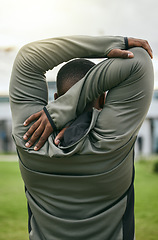 Image showing Fitness, back and stretching with a sports black man outdoor for a warm up before exercise or workout. Park, training and goals with a male athlete getting ready to run on a field for cardio