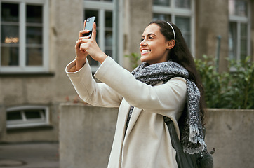 Image showing Travel, tourism and phone with a woman in the city taking a photograph while traveling on holiday or vacation. Tourist, traveler and mobile with a female photographing while sightseeing abroad