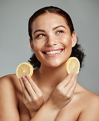 Image showing Face, beauty and lemon with a model black woman in studio thinking about natural skincare or treatment. Happy, smile and idea with an attractive young female posing to promote diet or nutrition