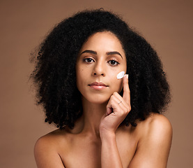 Image showing Cream, beauty and african woman in portrait for face, skincare and cosmetics promotion of product in studio. Black woman model with skin care glow, dermatology facial or sunscreen hand application