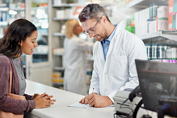 Image showing Patient, doctor and writing prescription at pharmacy for customer medical or healthcare need. Pharmacist helping woman with diagnosis, invoice or receipt at drugstore counter or pharmaceutical clinic