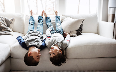 Image showing Children upside down, playful and happy at family home for fun with sibling, brothers on sofa and relax in living room. Happy people, love and quality time together, kid boys play with laughing