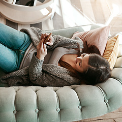 Image showing Social media, chat and above of woman on a phone for communication, app and contact on the sofa. Search, web and girl typing a conversation on a mobile for connectivity from a home on the sofa