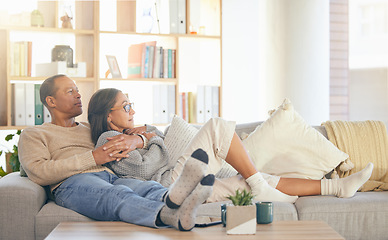 Image showing Senior couple, relax and sofa for hug, thinking or memory of life, love memory or bonding in home living room. Mature man, old woman and embrace on lounge couch for vision, care or support in Florida