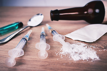 Image showing Powder, syringe and drugs with spoon on table for alcohol addiction, drug rehabilitation and narcotics abuse. Medicine, illegal products and drug problem for meth, cocaine and heroin solution