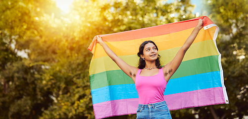 Image showing Love, nature and woman with pride flag, smile happy non binary lifestyle of freedom, peace and equality in Brazil. Trees, sun and summer fun for happy woman in lgbt community with flag for gay pride.