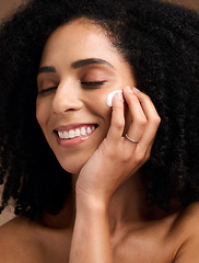 Image showing Black woman, skincare and cream for face, makeup and sunscreen product for wellness, luxury beauty and salon cosmetics. Happy model, facial lotion and natural dermatology, aesthetic and healthy glow