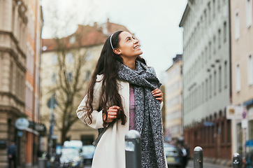 Image showing Walking, city buildings and woman travel on urban street, road or on holiday adventure journey In Chicago Illinois. Outdoor wanderlust, sidewalk and girl on tour journey of USA for winter vacation