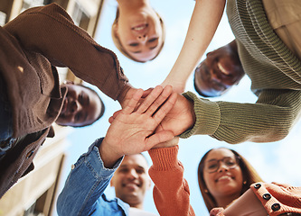 Image showing Friends smile, hands together in huddle and group diversity, team building in circle from below. Friendship, happiness and support, university students smiling, happy men and women on college campus.