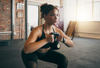 Image showing Fitness, kettlebell and a woman at gym doing workout, exercise and weight training for body wellness and muscle. Strong sports female or athlete with weights for power, energy and a healthy lifestyle