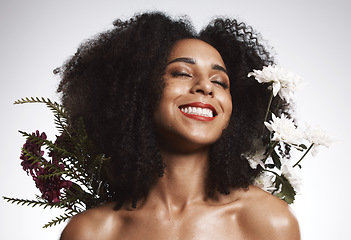 Image showing Black woman, beauty and flowers on studio background for healthy skincare. Happy face, floral plants and model with spring perfume, natural makeup and eco wellness for cosmetics, aesthetics and smile