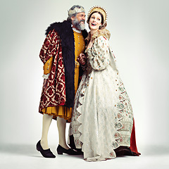 Image showing King, queen and love in medieval costume for royal party, retro carnival and theatre fashion clothes in white background. Couple, happy face and talking in vintage renaissance isolated in studio