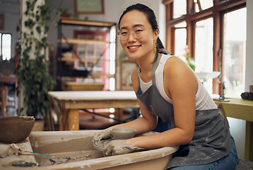 Image showing Pottery, startup business and creative woman portrait in her workshop for art with hands in mud. Asian artist with potter wheel for clay or ceramic retail industry, trade or production with pride