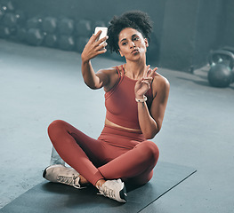 Image showing Fitness, selfie and woman on a gym floor with phone, peace and hand sign before exercise routine. Workout, picture and peace gesture by black woman posing for photo after training, emoji and relax