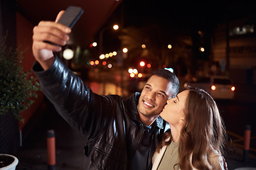 Image showing People, phone and night selfie kiss on cheek on city street, social media or profile picture in birthday celebration vlog. Happy smile, bonding or couple of friends on mobile photography tech in dark