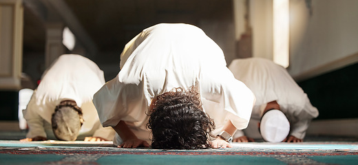 Image showing Muslim, prayer and mosque with a spiritual man group praying in faith during fajr, dhuhr or asr, otherwise maghrib or ishaa. Salah, worship and pray with islam men at ramadan for holy tradition