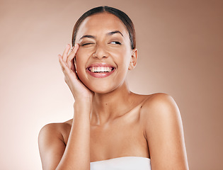 Image showing Skincare, beauty and happiness, portrait of woman with smile laughing on studio background. Makeup, glamour and wink, luxury skin care with hands on face, natural detox facial massage on happy woman