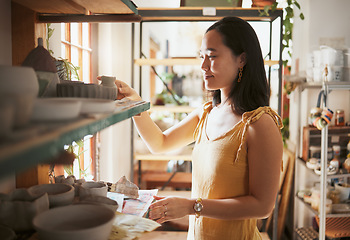 Image showing Pottery, startup and display with a woman entrepreneur working in a studio, selling products for retail. Small business, manager or sale with a female owner at work in a workshop for artistic design