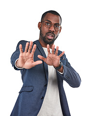 Image showing Shock, stop and portrait of a black man in a studio with a scared, fear and terrified face expression. Upset, mad and African male model with a defensive hand gesture isolated by a white background.