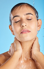 Image showing Woman, shower water and face of a calm model ready for morning skincare and wellness. Blue background, studio and isolated female relax with peace from facial beauty cleaning and self care alone