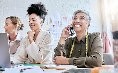 Image showing Designer, fashion and senior woman on phone call with contact in workshop. Group collaboration, small business and teamwork of female tailors in boutique with laptop planning, talking and discussing.