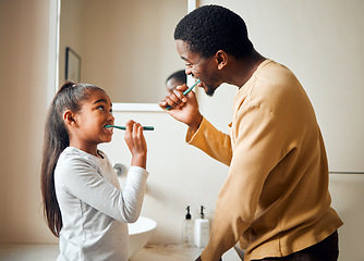 Image showing Brushing teeth, bonding and father with daughter in a bathroom for hygiene and dental grooming. Oral, care and girl with parent, teeth and cleaning with black family, playful and learning at home