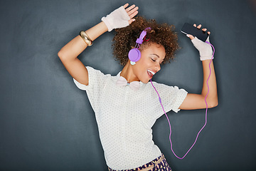 Image showing Phone music, dancing singer and black woman listening to song, audio podcast or radio sound for energy, relief or fun. Studio singing, dancer or retro dance student isolated on chalkboard background