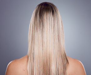 Image showing Hair care, blonde woman and back view of natural beauty, keratin texture and beauty salon cosmetics on studio background. Model, long hairstyle and scalp treatment for shine, glow and healthy shampoo