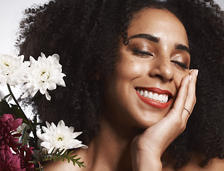 Image showing Makeup, flowers and happy black woman with skincare satisfaction and glowing texture routine. Aesthetic, health and wellness of confident cosmetics model with beautiful smile in white studio.