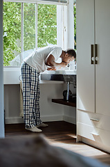 Image showing Black man brushing his teeth for dental health, hygiene or wellness in the bathroom of his home. Grooming, healthcare and young African guy cleaning his mouth for an oral care morning routine.