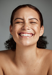 Image showing Face, beauty and funny with a model black woman in studio on a gray background laughing for skincare. Facial, wellness and makeup with an attractive young female happy with her skin product
