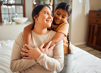 Image showing Love, hug and mother and daughter on a bed, bonding and sharing a sweet moment in their home together. Family, happy and girl embrace woman, smile and relax in a bedroom, content and cheerful